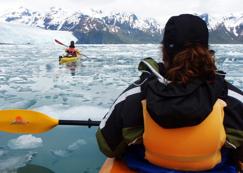 Kayakers among glacier ice