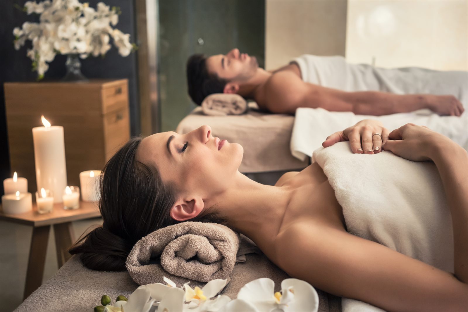 Couple relaxing side by side during a spa treatment